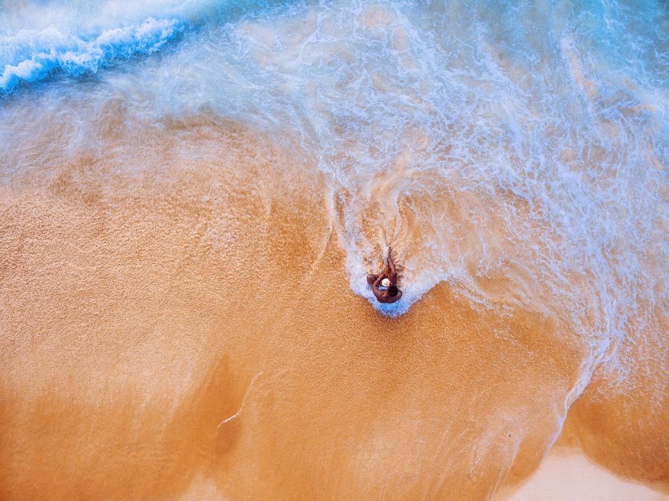 Aerial view of waves on a sandy beach