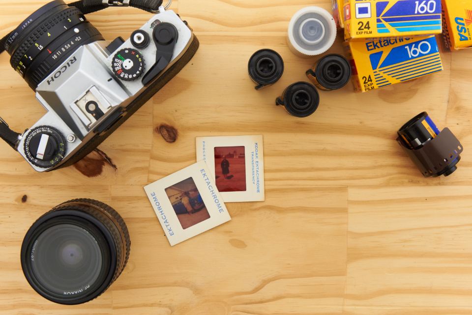 Vintage film cameras arranged on a wooden table